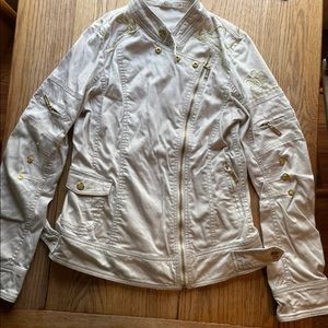 Tan MurMur jacket with lots of buttons, buckles, and zippers.